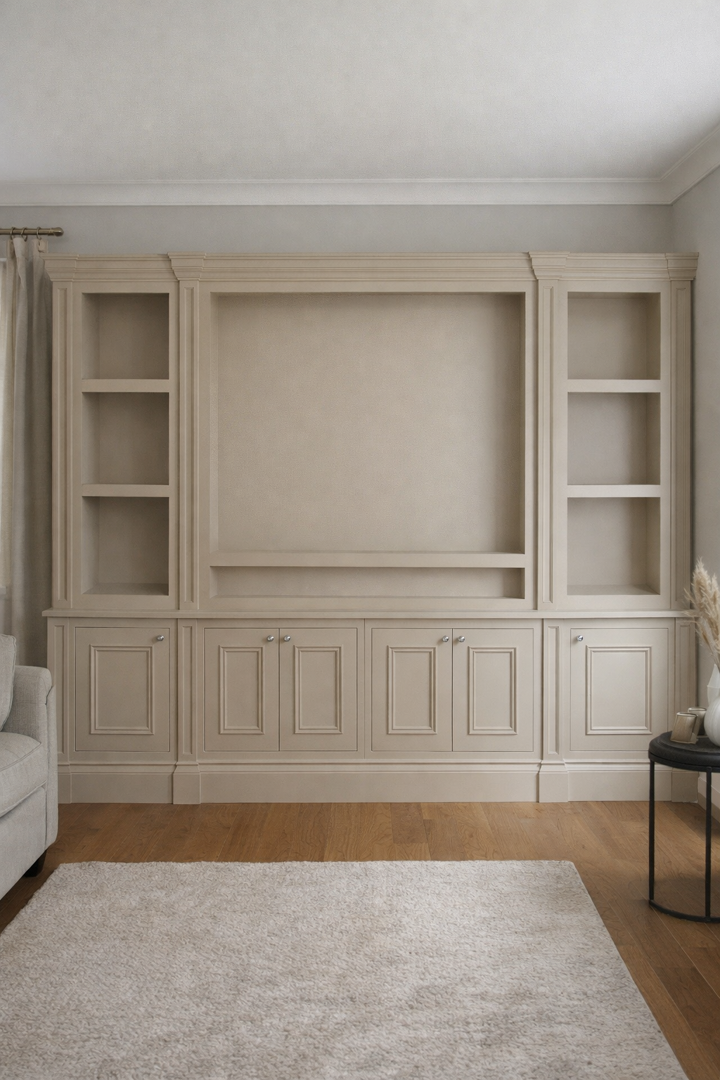 Bespoke media wall with integrated TV recess and shelving fitted in a West Midlands living room