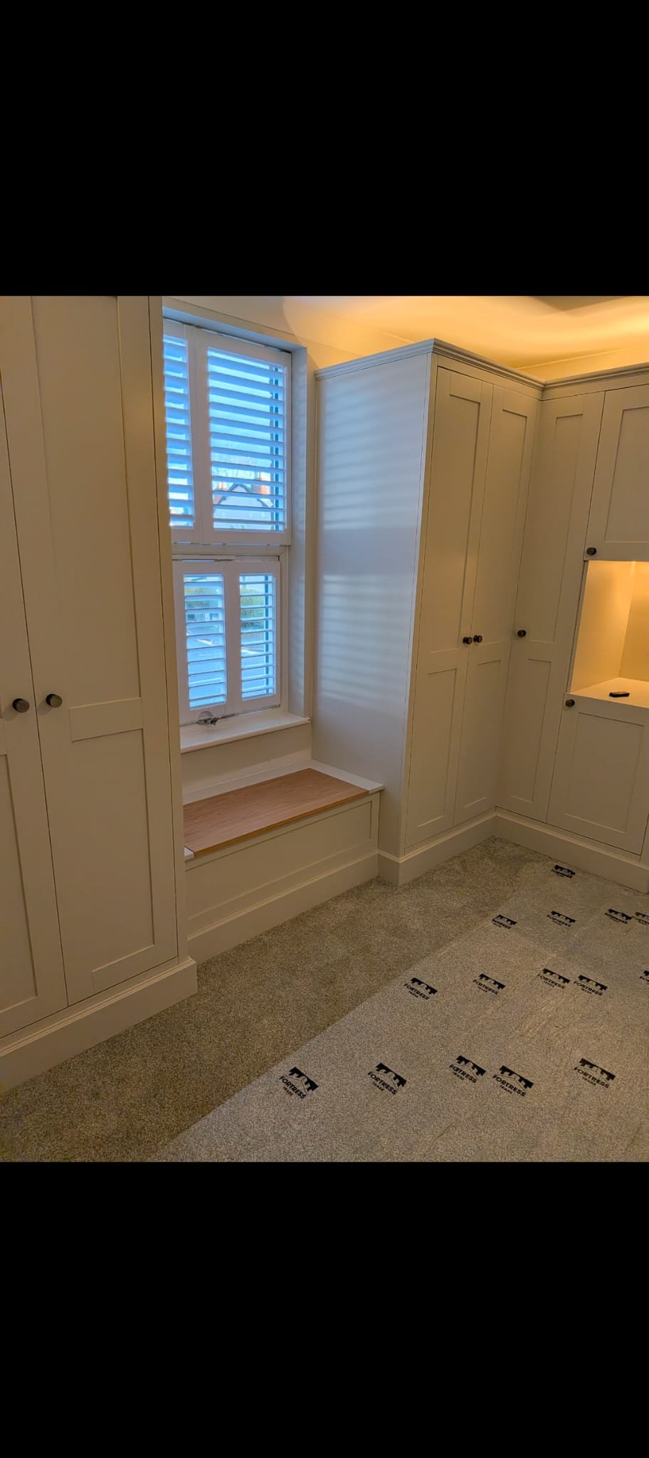 Bespoke fitted wardrobe with shaker-style doors built into an alcove